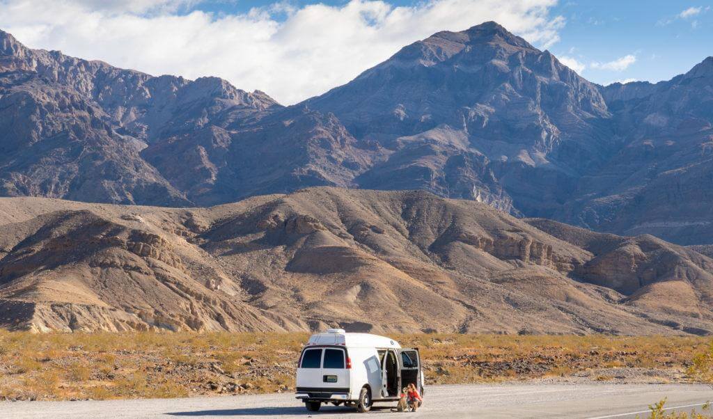 VanLife Parked on the Side of the Road with Huge Mountains Behind It