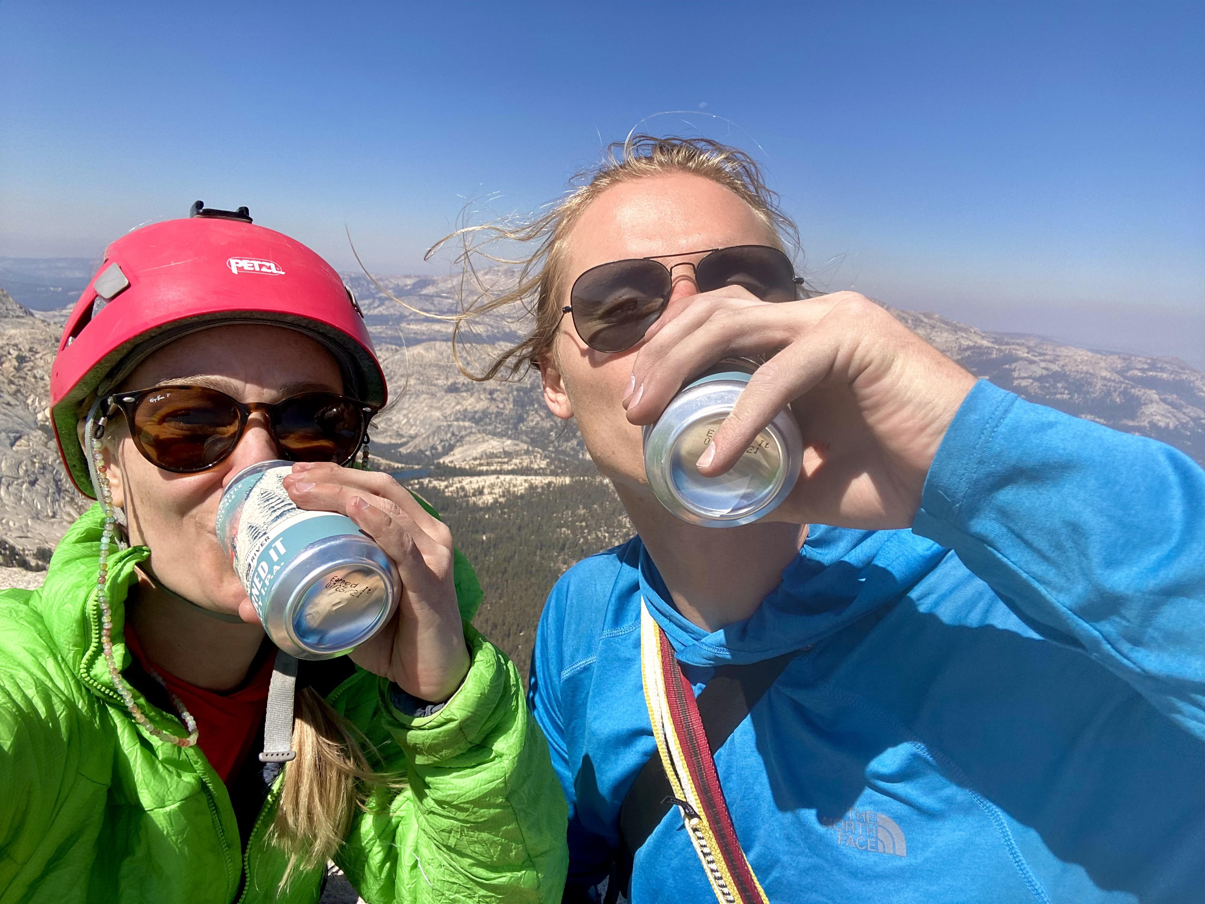 Sentry and Isabel drinking a beer on a climb