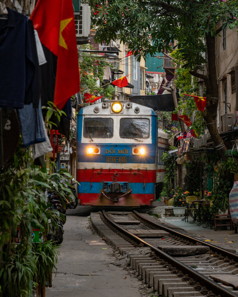 Train coming down a narrow street in Hanoi, Vietnam
